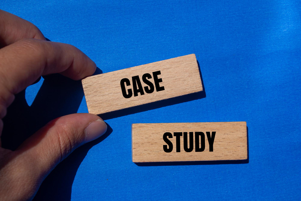 Fingers placing wooden tiles that read case study