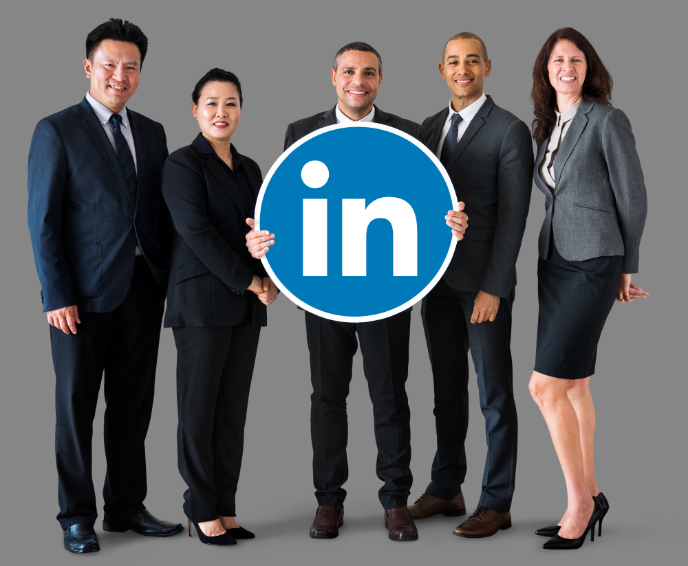 Business people holding LinkedIn logo