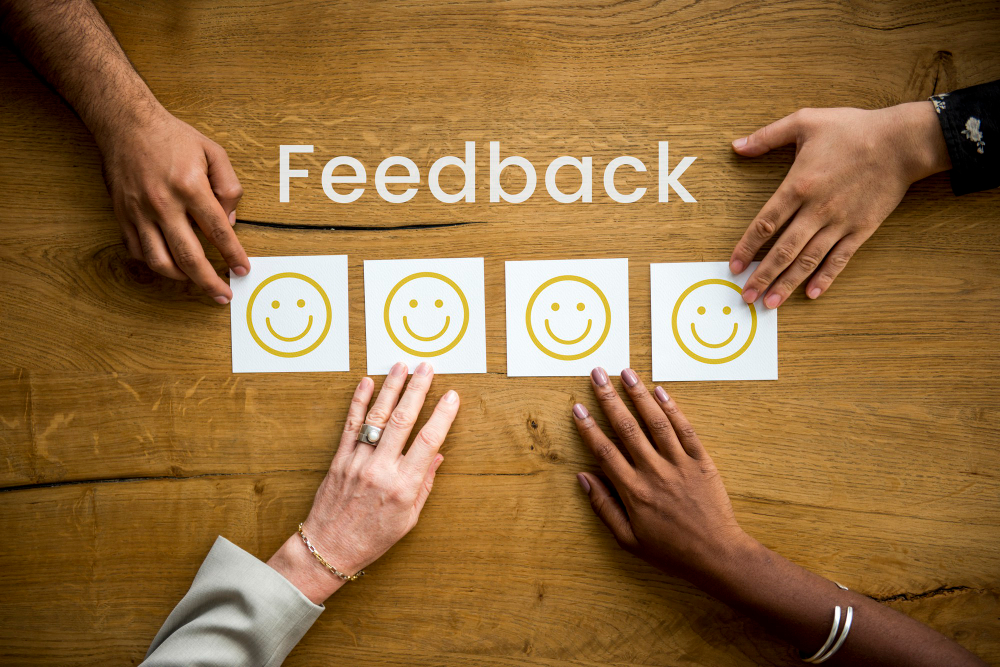 Feedback written on a desk with smiley faces