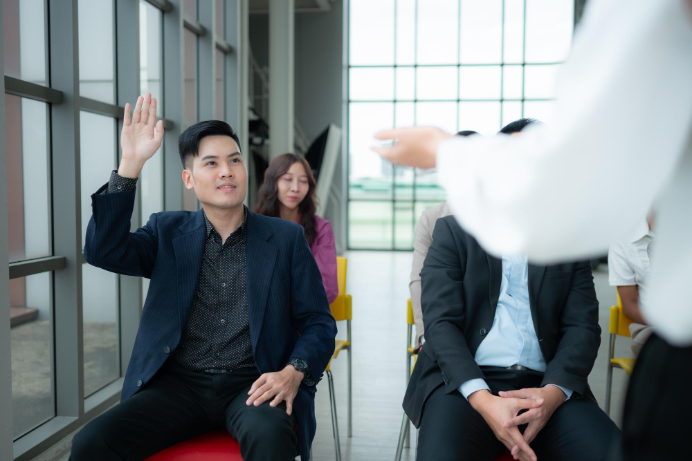 Engaged employee raising his hand