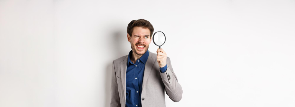 man with magnifying glass searching for proof