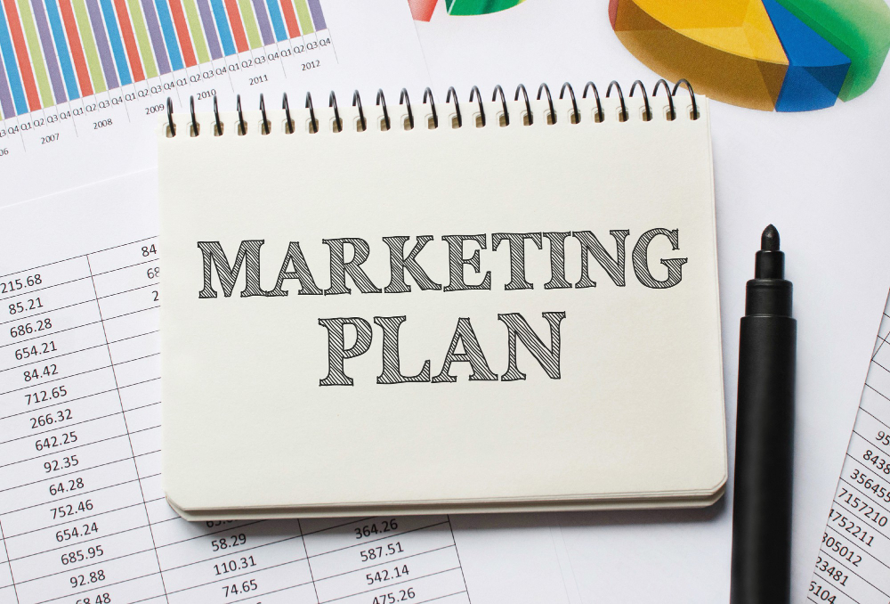 Marketing plan written on a note pad