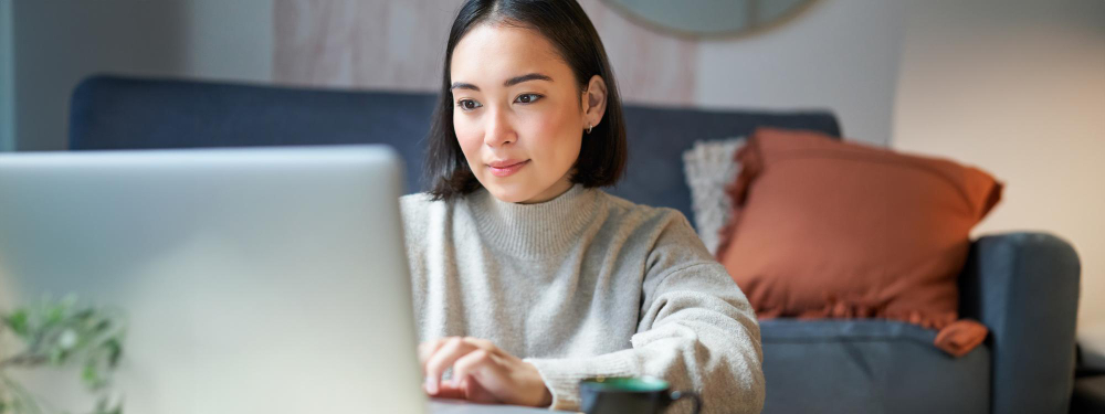 Young lady sitting at laptop